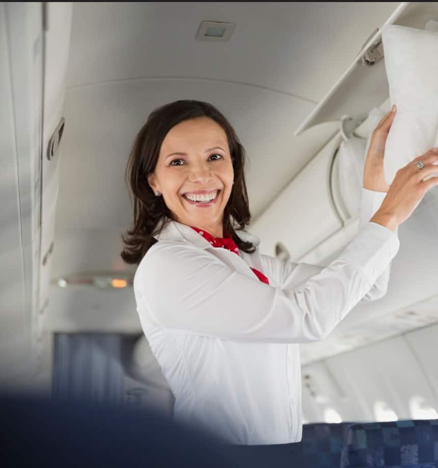 Air-hostess keeping the pillow for the passenger in the flight.